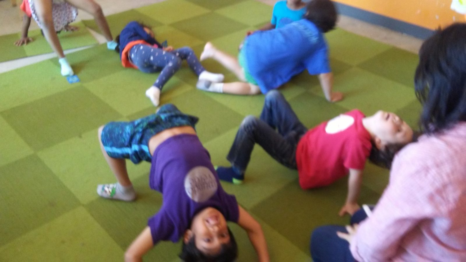 Kids laughing during movement activity in Spanish class