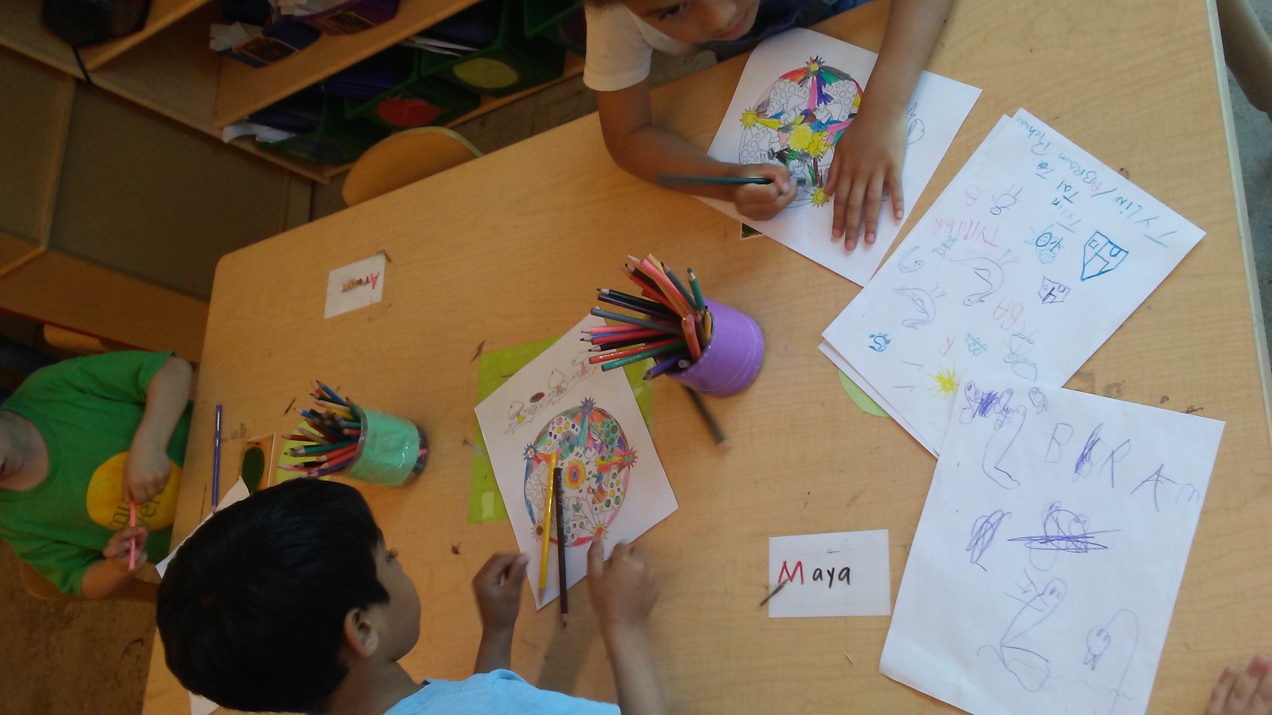 Children coloring at the table in after-school Spanish class